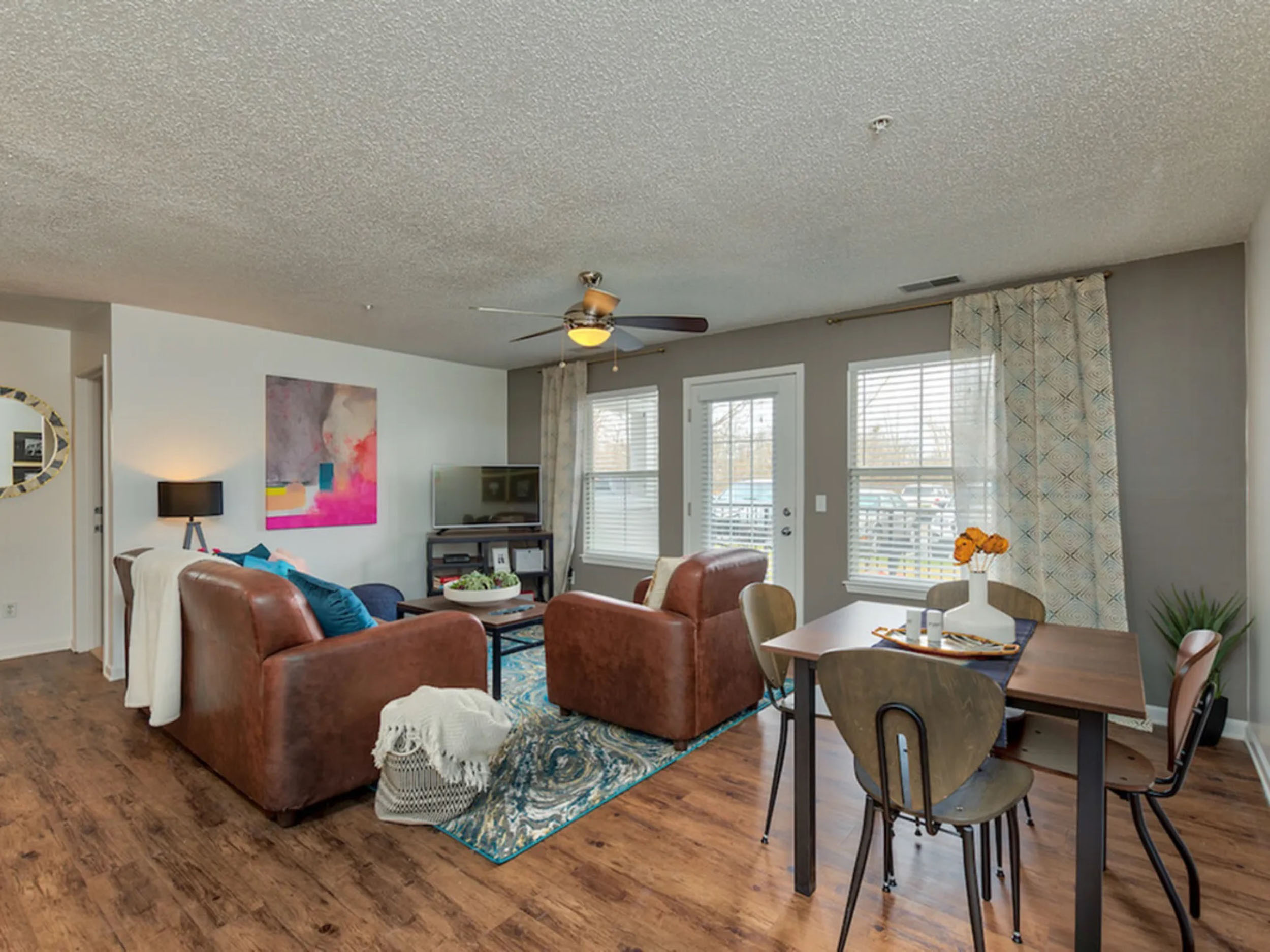 a living room with a table and chairs