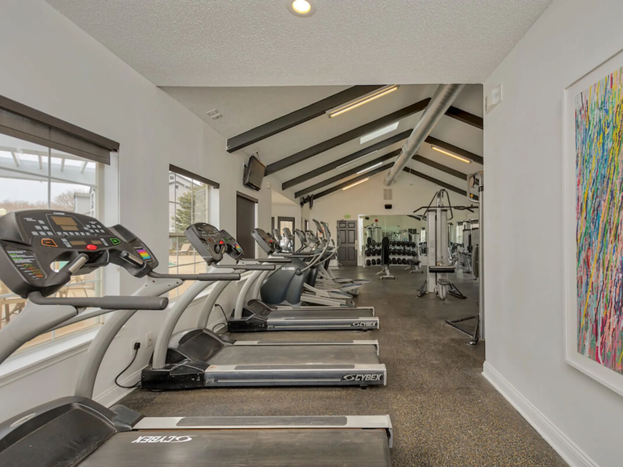a room with treadmills and exercise equipment